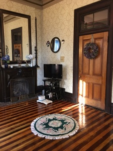 Gas fireplace with black mantle and large mirror above - mansion amenities